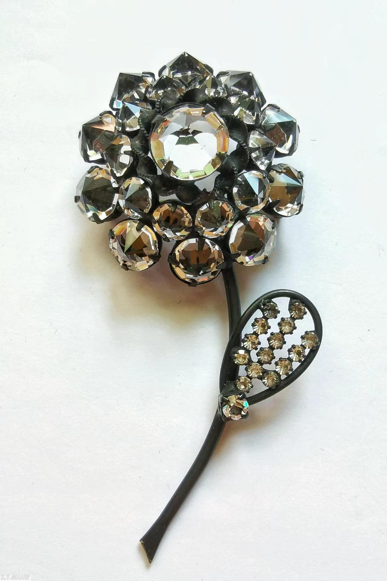 Schreiner long stem inverted stone 1 flower 1 leaf pin flower 1 large round stone center 10 surrounding stone wire border leaf 14 small inverted chaton inverted crystal gunmetal jewelry