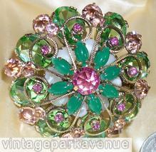 Schreiner 2 level 8 scrollwork radial pin large round chaton center 8 surrounding navette bottom 8 large oval stone 8 large round cab celery green large faceted oval stone jade navette fuschia large inverted round center peach inverted large stone moonglow white round cab goldtone jewelry