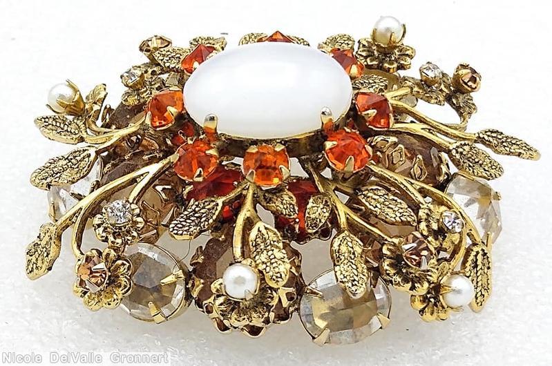 Schreiner 2 level oval radial pin 10 metal leaf flower branch large oval cab center 6 large chaton 8 surrounding small chaton brown large chaton orange small chaton faux pearl large moonglow oval cab brown large chaton goldtone jewelry
