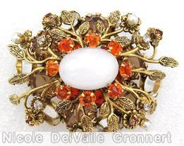 Schreiner 2 level oval radial pin 10 metal leaf flower branch large oval cab center 6 large chaton 8 surrounding small chaton brown large chaton orange small chaton faux pearl large moonglow oval cab brown large chaton goldtone jewelry