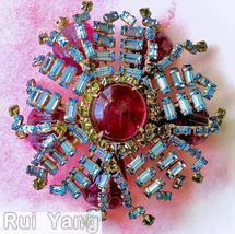 Schreiner 2 level radial pin large round cab center 16 small surrounding stone 20 branch of bagette bottom 5 teardrop marbled raspberry round cab center ice blue small baguette peridot small inverted stone raspberry teardrop art glass goldtone jewelry