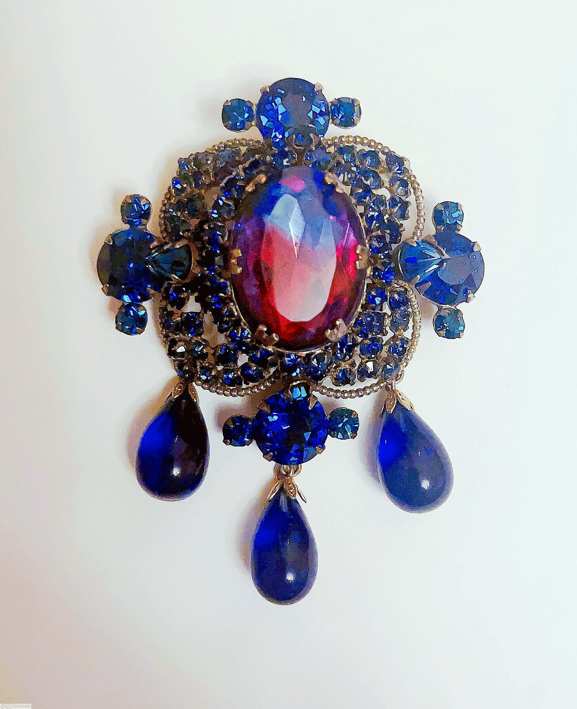 Schreiner 3 dangle top down pin large oval cab center top surrounding 3 round small stone in 4 wired pedal 4 large chaton large bicolor ruby navy faceted oval stone center royal blue goldtone jewelry