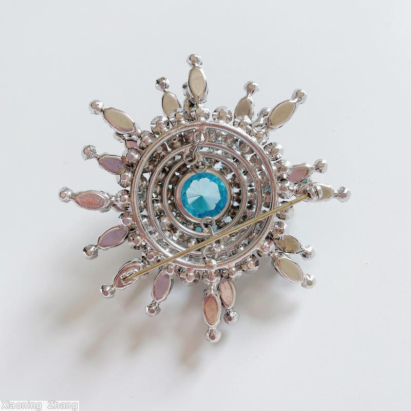 Schreiner 3 level domed radial 8 branch star burst pin large round stone center 14 surrounding small chaton branch 1 navette 1 small chaton moonglow white ice blue clear large faceted round stone brown silvertone jewelry