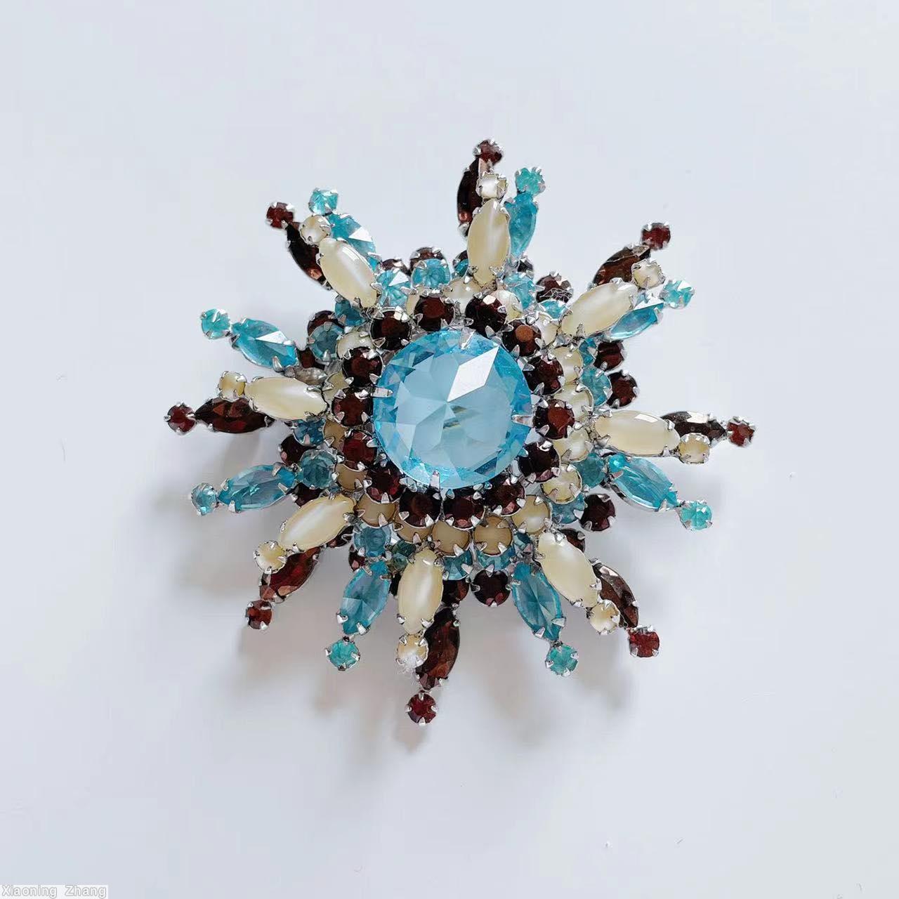 Schreiner 3 level domed radial 8 branch star burst pin large round stone center 14 surrounding small chaton branch 1 navette 1 small chaton moonglow white ice blue clear large faceted round stone brown silvertone jewelry
