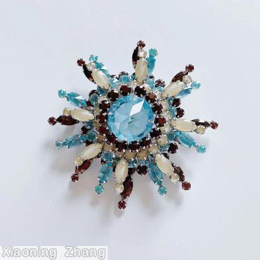 Schreiner 3 level domed radial 8 branch star burst pin large round stone center 14 surrounding small chaton branch 1 navette 1 small chaton moonglow white ice blue clear large faceted round stone brown silvertone jewelry