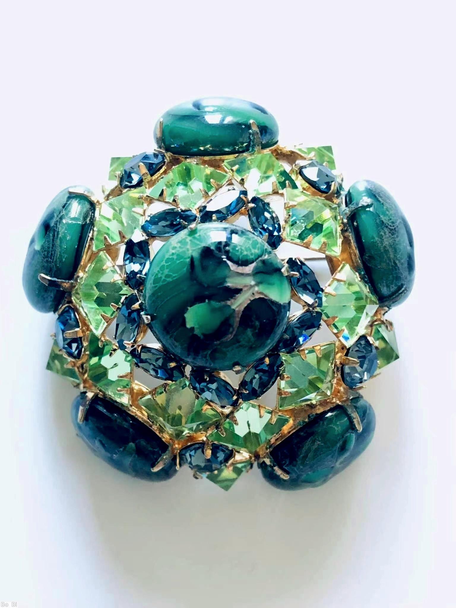 Schreiner 3 rounds domed radial pin 6 large round art glass stone 8 surrounding tilted navette 2nd round 10 faceted square stone side wall 5 large round stone marbled green large round cab celery faceted square stone blue small faceted navette goldtone jewelry