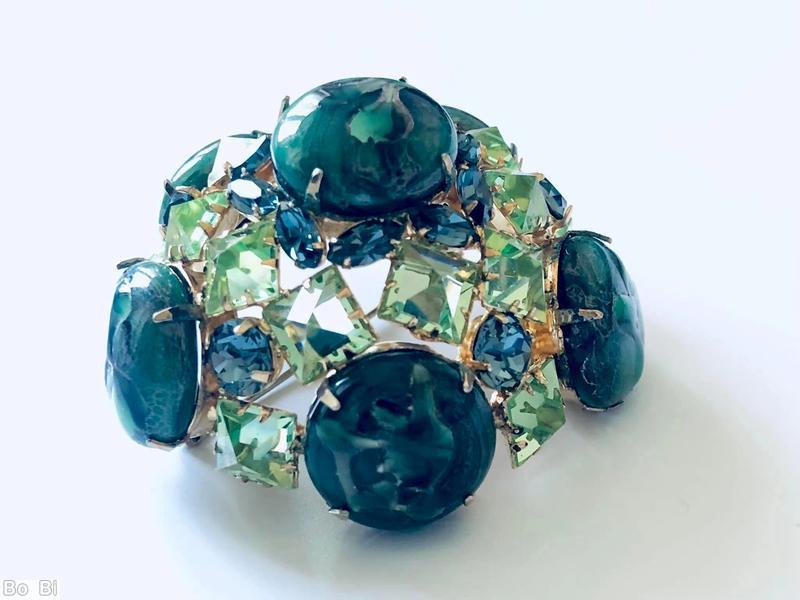 Schreiner 3 rounds domed radial pin 6 large round art glass stone 8 surrounding tilted navette 2nd round 10 faceted square stone side wall 5 large round stone marbled green large round cab celery faceted square stone blue small faceted navette goldtone jewelry