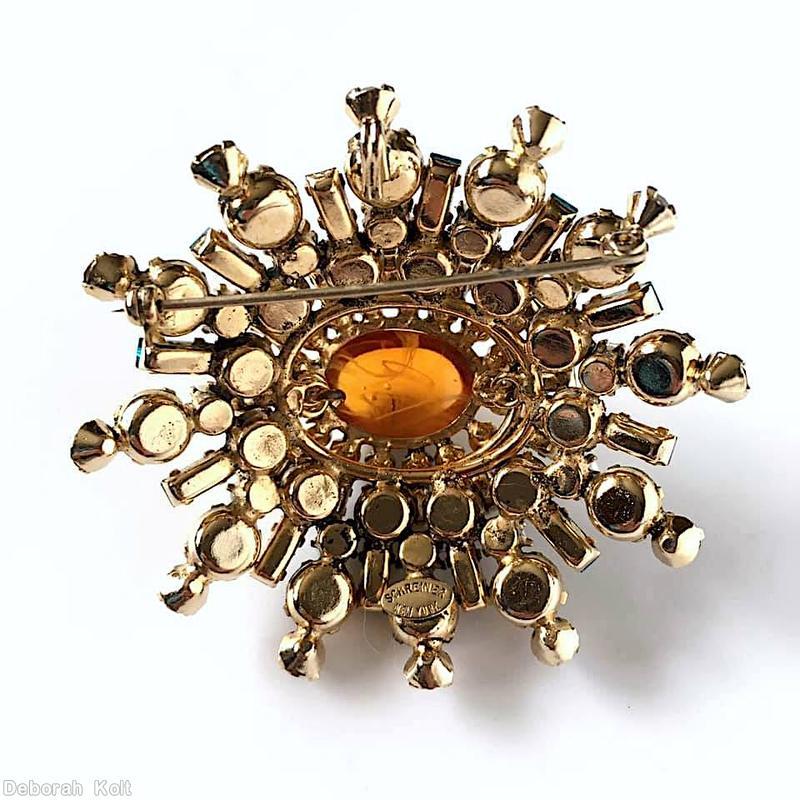 Schreiner 5 rounds varied length domed radial oval pin large oval center 16 small surrounding chaton small baguette swirled topaz large oval cab center ice blue small chaton metallic chocolate chaton blue small baguette faux pearl goldtone jewelry