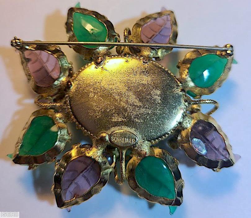 Schreiner 8 carved leaf radial pin large oval molded flower center stone 4 flower branch with faux pearl center 6 small chaton around green carved leaf purple carved leaf emerald large oval molded flower stone purprle small chaton goldtone jewelry