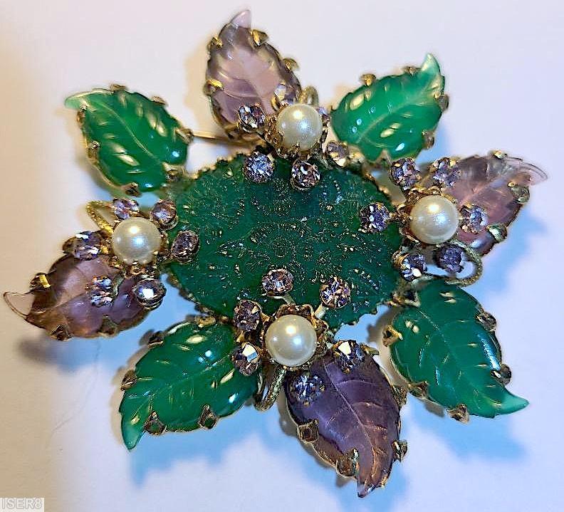Schreiner 8 carved leaf radial pin large oval molded flower center stone 4 flower branch with faux pearl center 6 small chaton around green carved leaf purple carved leaf emerald large oval molded flower stone purprle small chaton goldtone jewelry