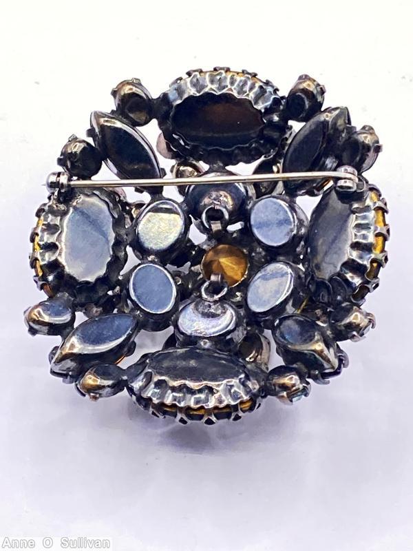 Schreiner domed 4 large oval radial pin 3 rounds 6 surrounding small chaton center chaton 6 small oval stone 4 large navette clear blue center chaton topaz large navette dark olivine large oval cabochon amber small oval cabochon jewelry