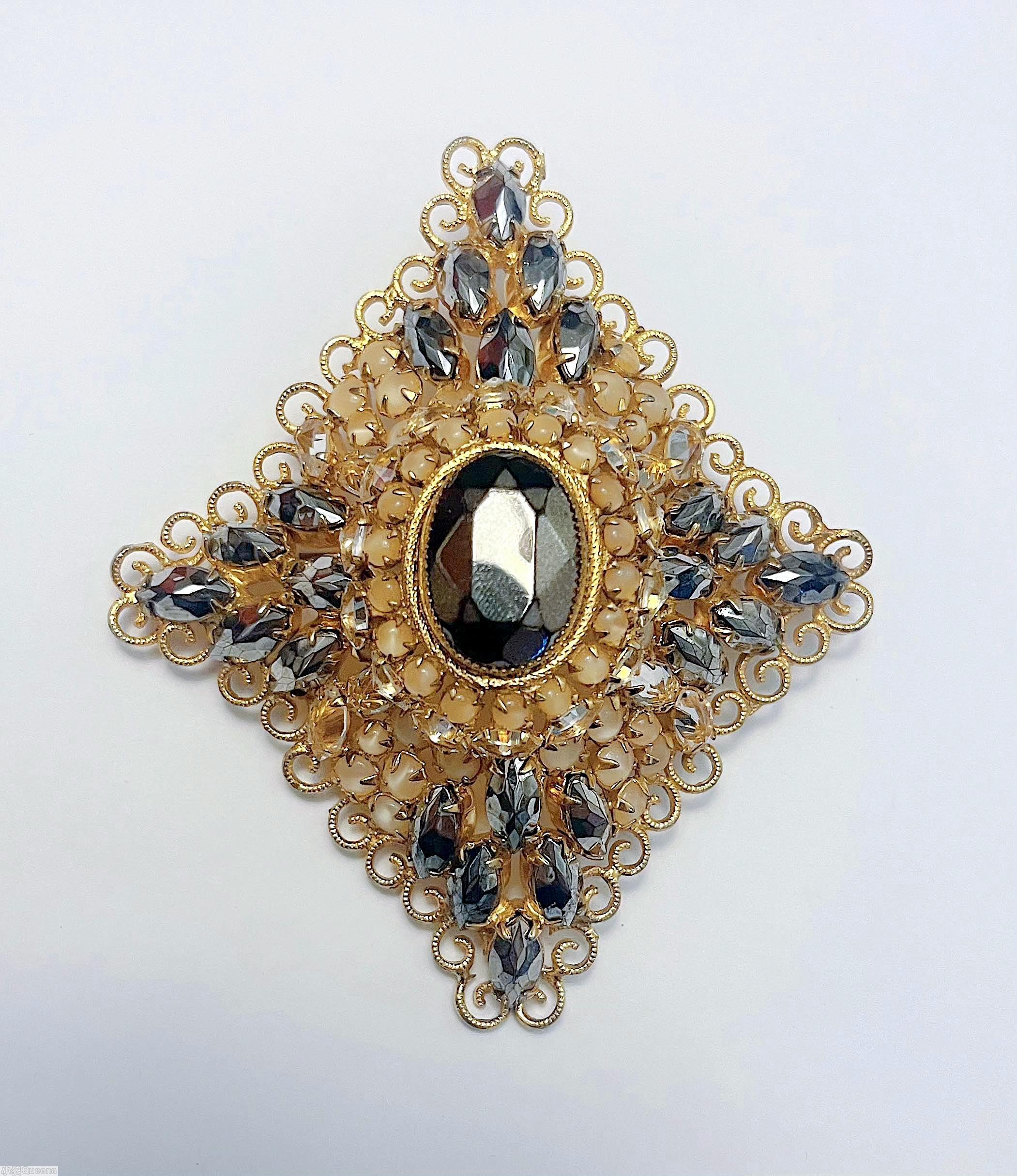 Schreiner domed radial diamond shaped pin large oval center 18 surrounding small chaton 18 navette scrollwork hematite navette moonglow champagne chaton large faceted oval hematite center goldtoned jewelry