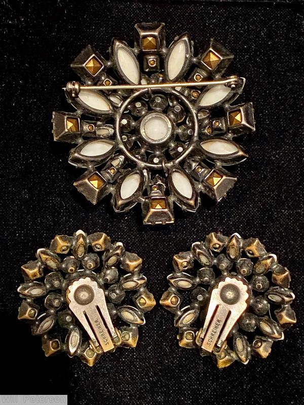 Schreiner domed round raditing pin 3 rounds round cabochon center 9 surrounding small chaton 9 small navette 9 small square 8 navette 8 square milk white crystal jewelry