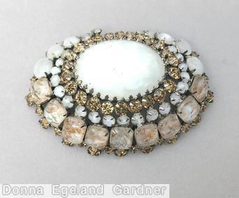 Schreiner eccentric radial oval pin large oval center 4 rounds white white venetian champagne moonglow white jewelry