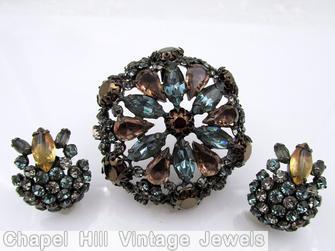 Schreiner hexagonal domed radial concave flat top pin small chaton center 6 surrounding navette 6 round stone on side wall smoky blue smoky topaz metalic brown crystal pale green jewelry
