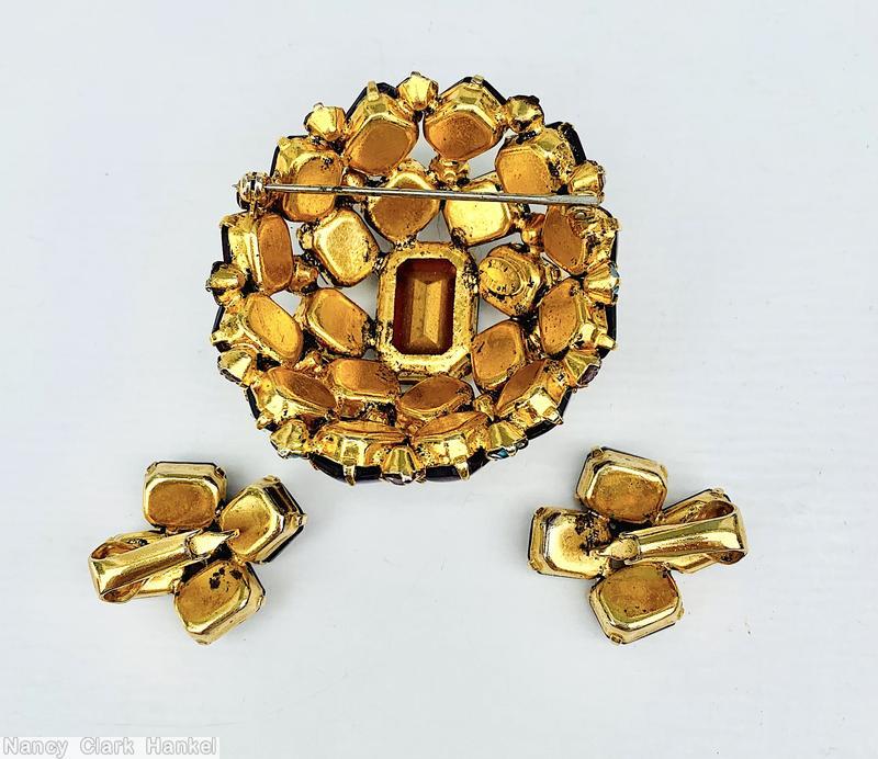 Schreiner high domed oval 20 emerald cut stone pin large emerald cut center 8 surrounding stone 12 second round stone small chaton ice blue pink fluss lapis goldtone jewelry