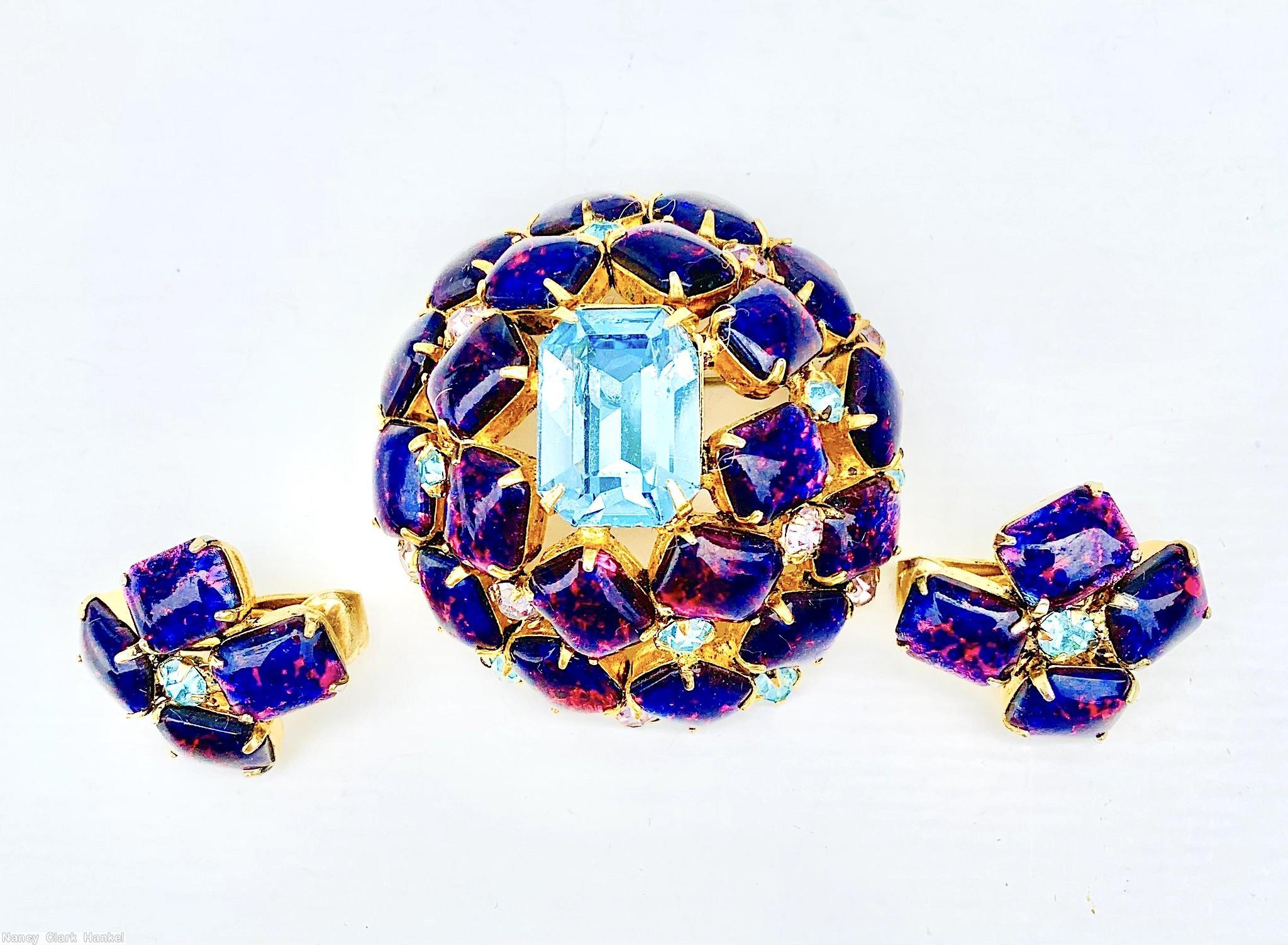 Schreiner high domed oval 20 emerald cut stone pin large emerald cut center 8 surrounding stone 12 second round stone small chaton ice blue pink fluss lapis goldtone jewelry