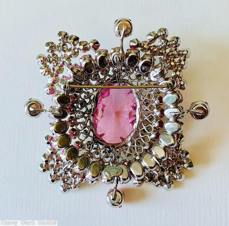 Schreiner large oval shaped domed radial pin large oval faceted crystal center 23 surrounding small chaton 26 small oval stone 4 single chaton branch 4 wide arrow head branch large faceted pink crystal center clear champagne small chaton apple green moonglow small chaton opaque fuschia small oval stone opaque pink chaton moonglow fuchsia small chaton jewelry