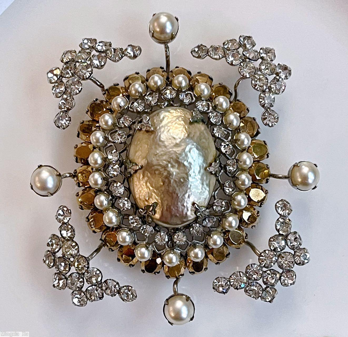 Schreiner large oval shaped domed radial pin large oval faceted crystal center 23 surrounding small chaton 26 small oval stone 4 single chaton branch 4 wide arrow head branch large oval baroque pearl center surrounding small crystal chaton faux pearl small oval facete topaz jewelry
