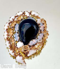 Schreiner large pear shaped dollop center swirling pin 7 surrounding navette 3 rounds large teardrop large jet pear shaped dollop opal navette milk white navette milk white large teardrop clear champagne navette goldtone jewelry