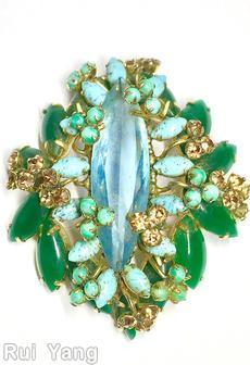 Schreiner long elongated faceted stone center stone 14 flower head 14 large navette 13 surrounding navette clear aqua center turquoise small surrounding navette emerald navette brown moonglow green goldtone jewelry