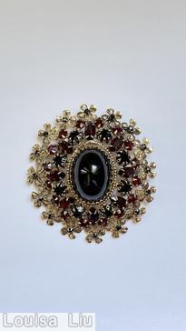 Schreiner oval 16 metal flower radial pin large oval cab center 8 surrounding small navette 8 small chaton jet large oval cab ruby small navette jet small chaton goldtone jewelry