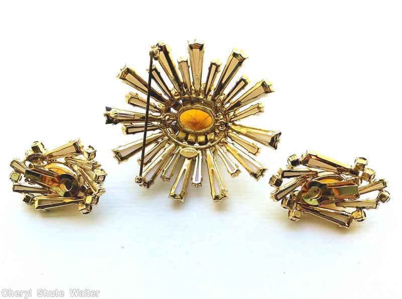 Schreiner oval high domed keystone ruffle pin large oval center varied length keystone white keystone marbled amber large oval cab center peridot 2 round surrounding chaton goldtone jewelry