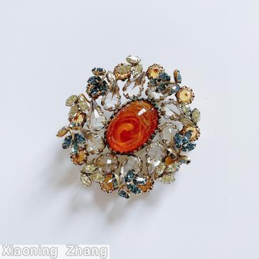 Schreiner oval radial pin large oval center cab 10 surrounding swirling teardrop 10 small branch marbled topaz large oval center cab crystal teardrop smoky blue small navette topaz inverted chaton small crystal oval stone goldtone jewelry