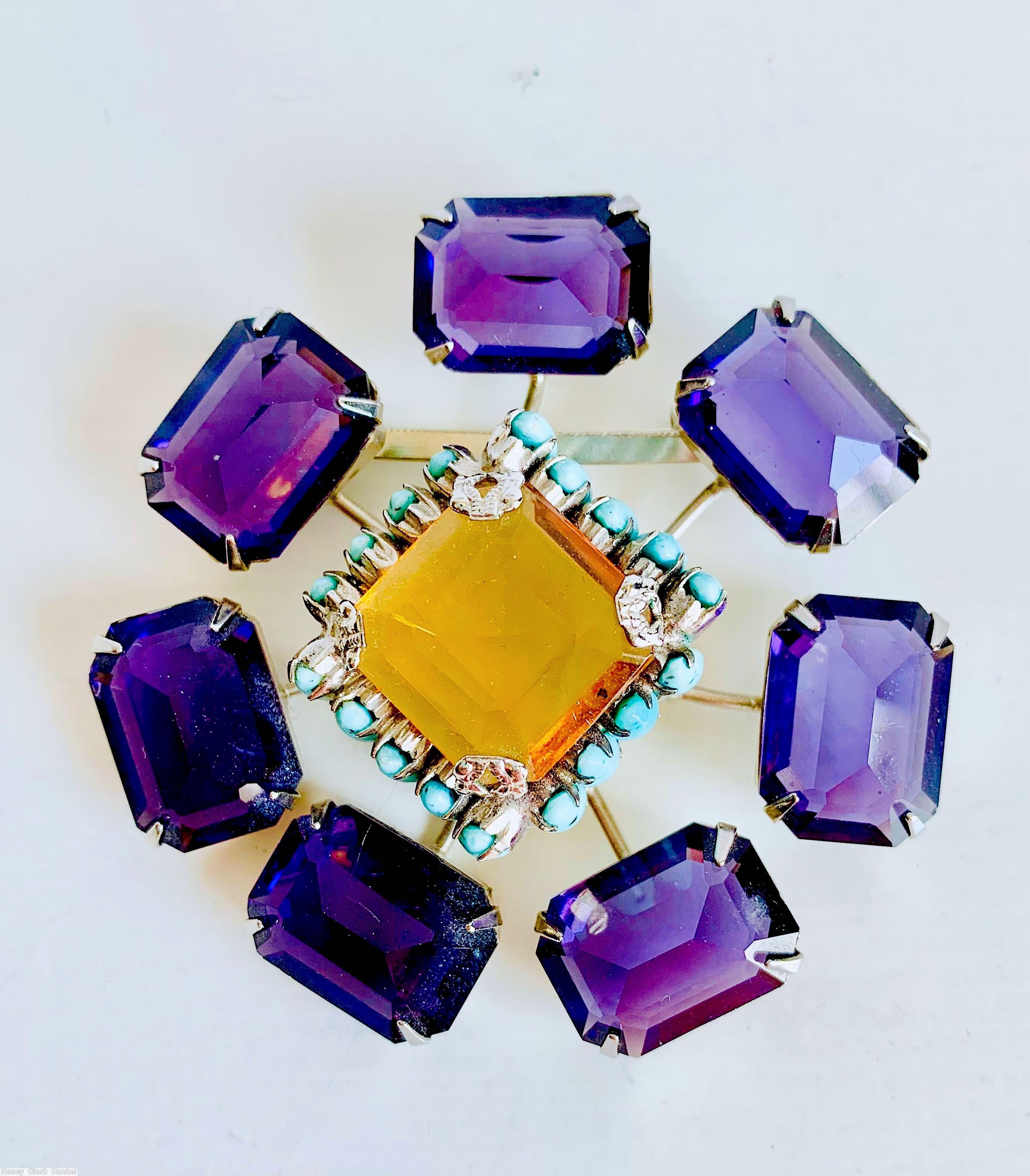 Schreiner radial 7 stem large emerald cut 1 large square faceted crystal highly domed center 18 surrounding small oval stone purple large emerald cut topaz large square faceted center turquoise small oval stone silvertone jewelry