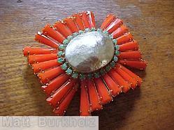 Schreiner radial keystone ruffle cross pin large oval center hook eye coral keystone large oval metalic faux pearl 1 round surrounding green small chaton jewelry