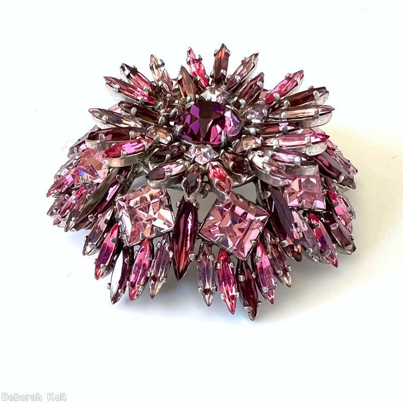 Schreiner round shaped flat top radial navette pin large chaton center 6 small square surrounding stone 6 navette surrounding stone 8 large square stone purple faceted large round stone center peach small square stone pink navette clear ice pink square stone lavender navette silvertone jewelry