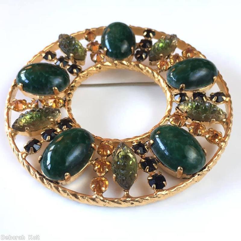 Schreiner round shaped shadow box radial pin ornamental metal frame 5 large oval stone 5 large jelly bean dark emerald large oval stone bicolor bronze green cracked ice navette jet small chaton topaz small chaton goldtone jewelry