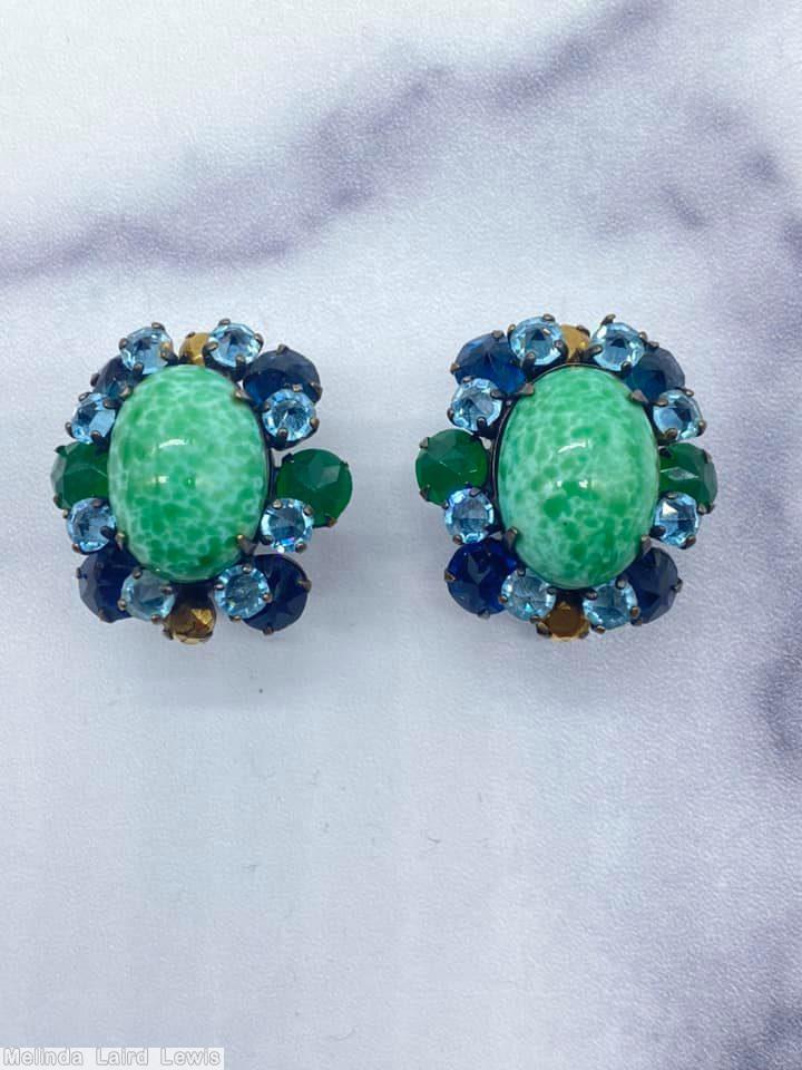 Schreiner 1 large oval cab center 16 surrounding small stone large oval peking glass center emerald chaton inverted small ice blue navy metalic brown chaton jewelry