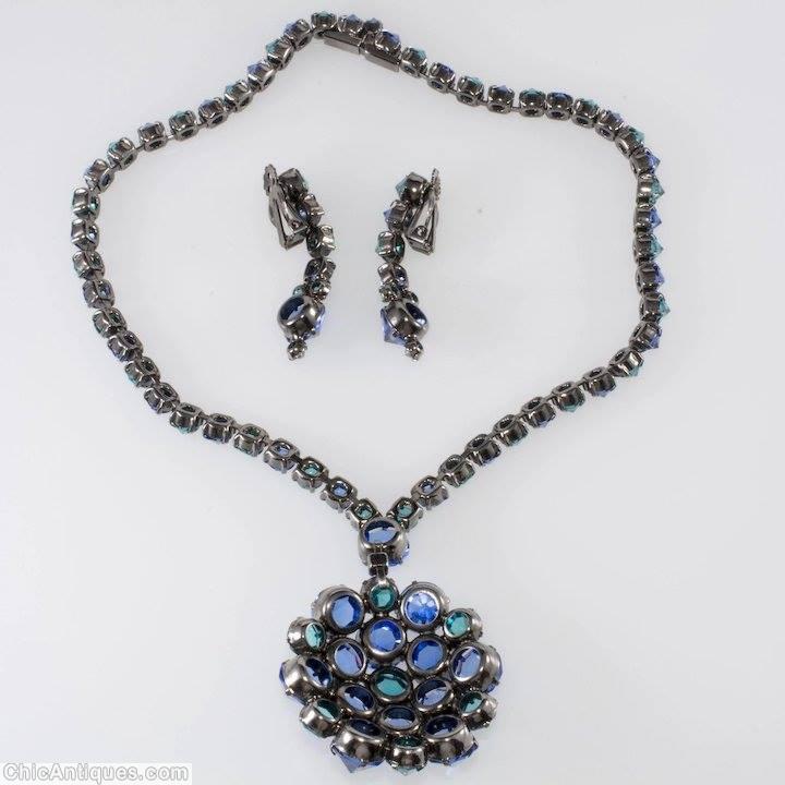 Schreiner highly domed radial pin 19 inverted stone 6 surrounding invertd 1 inverted large round stone single strand of small square stone clear navy aqua all inverted silvertone jewelry