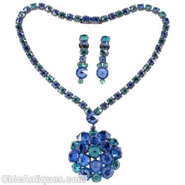 Schreiner highly domed radial pin 19 inverted stone 6 surrounding invertd 1 inverted large round stone single strand of small square stone clear navy aqua all inverted silvertone jewelry