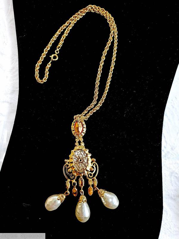 Schreiner 3 part top dangling scrollwork pendant top part oval stone cab middle part large oval cab scrollwork bottom 3 dangling teardrop connected to navette large oval baroque faux pearl large oval faceted crystal goldtone jewelry
