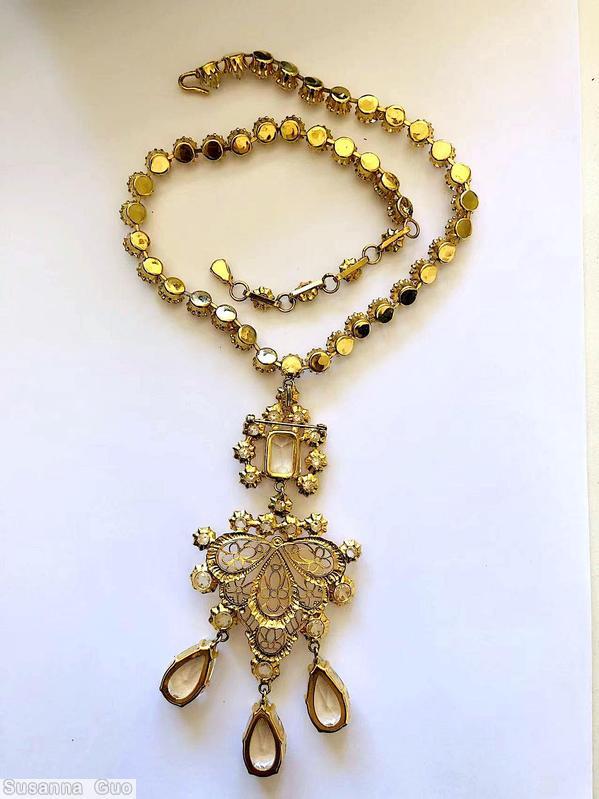 Schreiner top large emerald cut with 8 surrounding chaton down 3 dangling teardrop with 11 varied size chaton and filigree gold filigree large teardrop dangling crystal clear champagne inverted stone goldtone jewelry