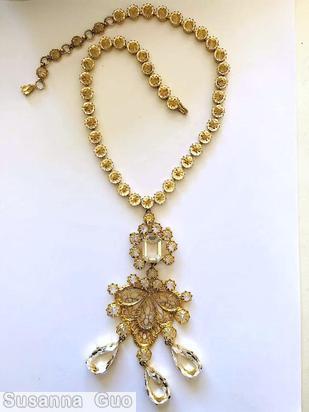 Schreiner top large emerald cut with 8 surrounding chaton down 3 dangling teardrop with 11 varied size chaton and filigree gold filigree large teardrop dangling crystal clear champagne inverted stone goldtone jewelry